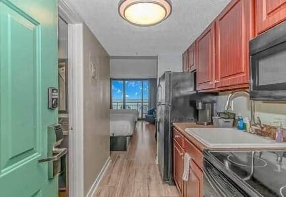 elcome in! Bright entryway with a fully equipped kitchenette and ocean views straight ahead.