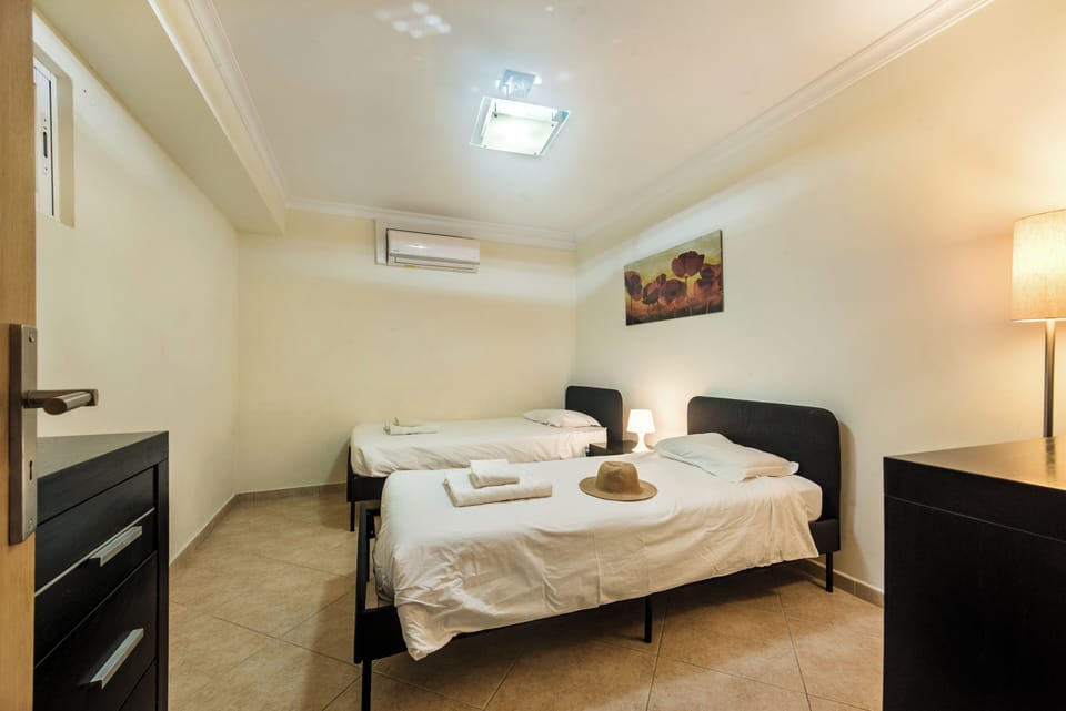 Twin bedroom close to games room at swimming pool level