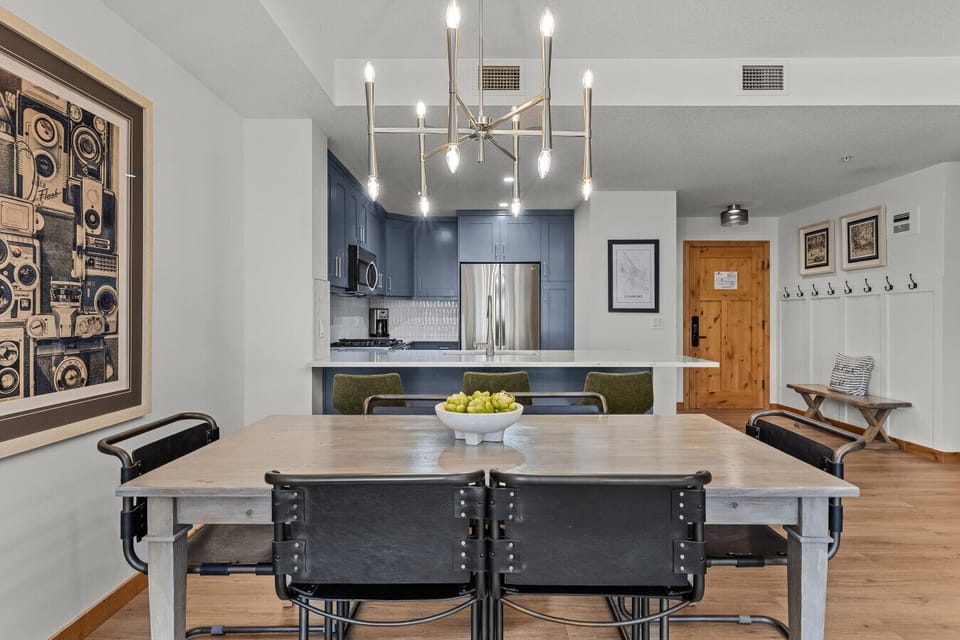 Modern dining area crowned by a exquisite dainty chandelier