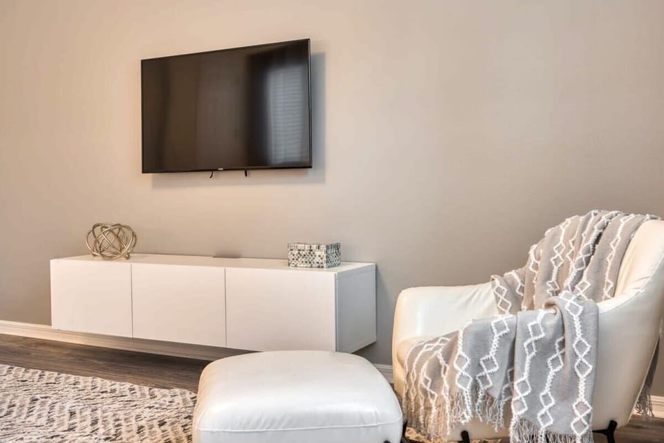Bedroom 1 includes a comfortable sitting area, perfect for reading.