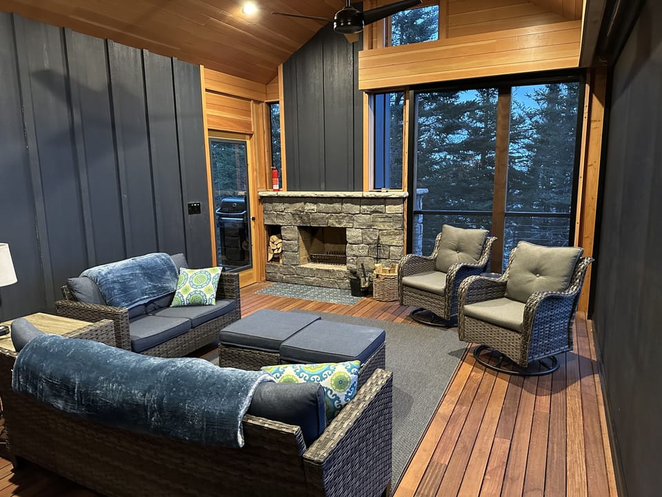 Screen porch with wood burning fireplace.