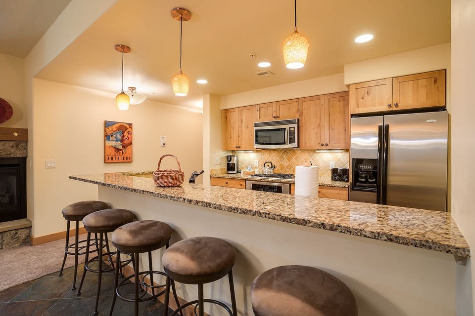 Your fully equipped kitchen features granite counters, stainless appliances, and breakfast bar seating for memorable meal prep.