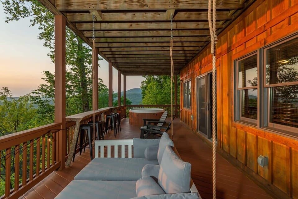The lower deck is full of space to relax, either in the hot tub or on the swinging day bed!
