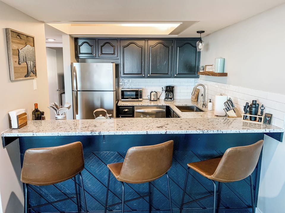 Three bar stools allow for socializing and cooking at the same time.