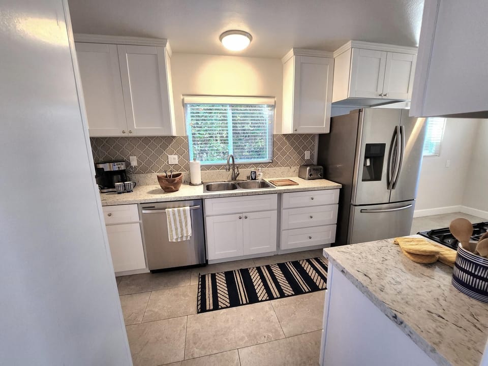 Sunny kitchen with lots of counter space and wide area of circulation.