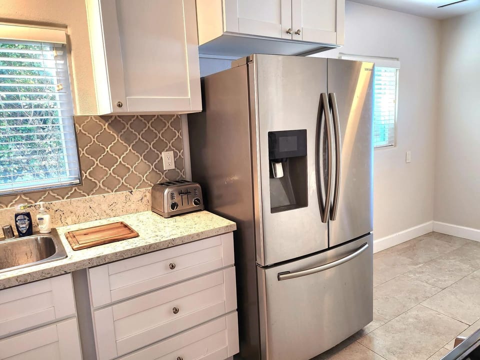 Double door refrigerator with freezer on bottom.  Dual ice makers 