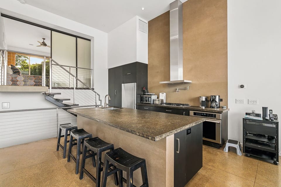 Kitchen with view of stairs going up to secondary master.