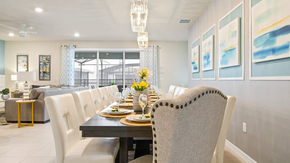 Elegant dining area with seating for a crowd, modern decor, and natural light.
