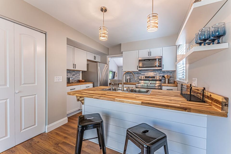 Well-equipped kitchen with modern appliances including a Keurig. The Kitchen also includes a breakfast bar with seating.