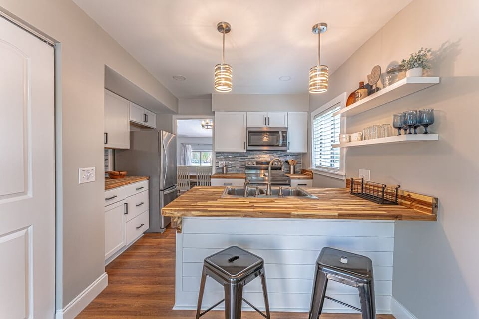 Beautifully furnished and well-equipped kitchen with modern appliances including a Keurig.
The Kitchen also includes a breakfast bar with seating.