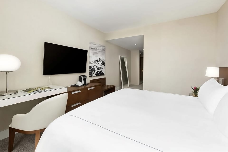 Stretch out on plush bedding and enjoy easy in-room entertainment.