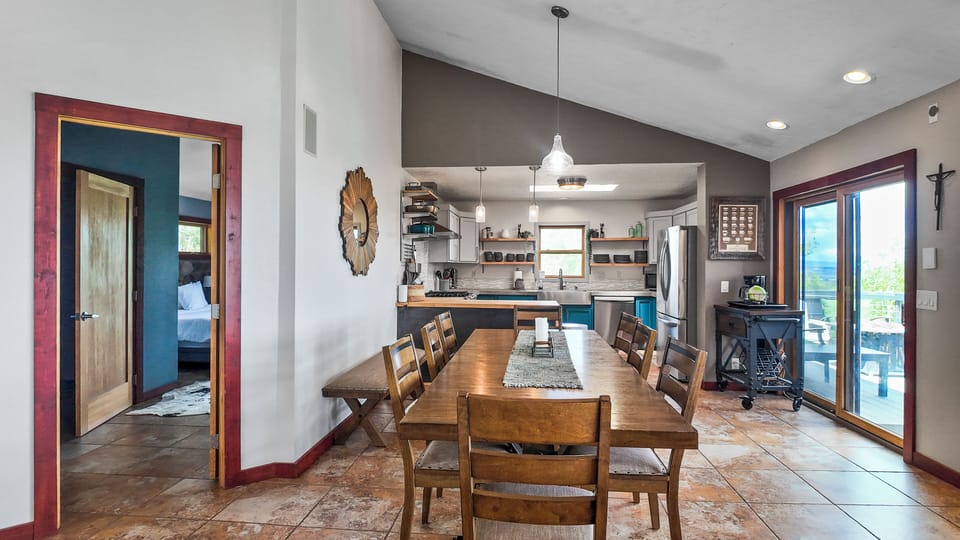 Spacious dining table with kitchen access, perfect for large meals.