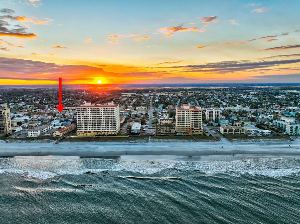 Aerial view of Jacksonville Beach - arrow shows Oceanwalk Manor, just steps from the sand