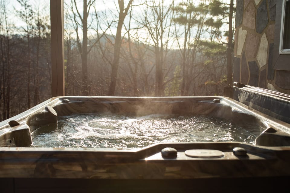 Hot tub in the covered portch overlooking the mountain. 