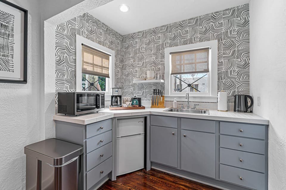 The guest house kitchenette with its chic, contemporary design comes equipped with a fridge, microwave and full coffee setup.