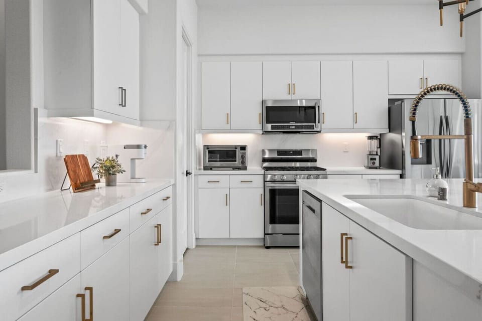 Fully equipped kitchen w/ stainless appliances & generous counter space.