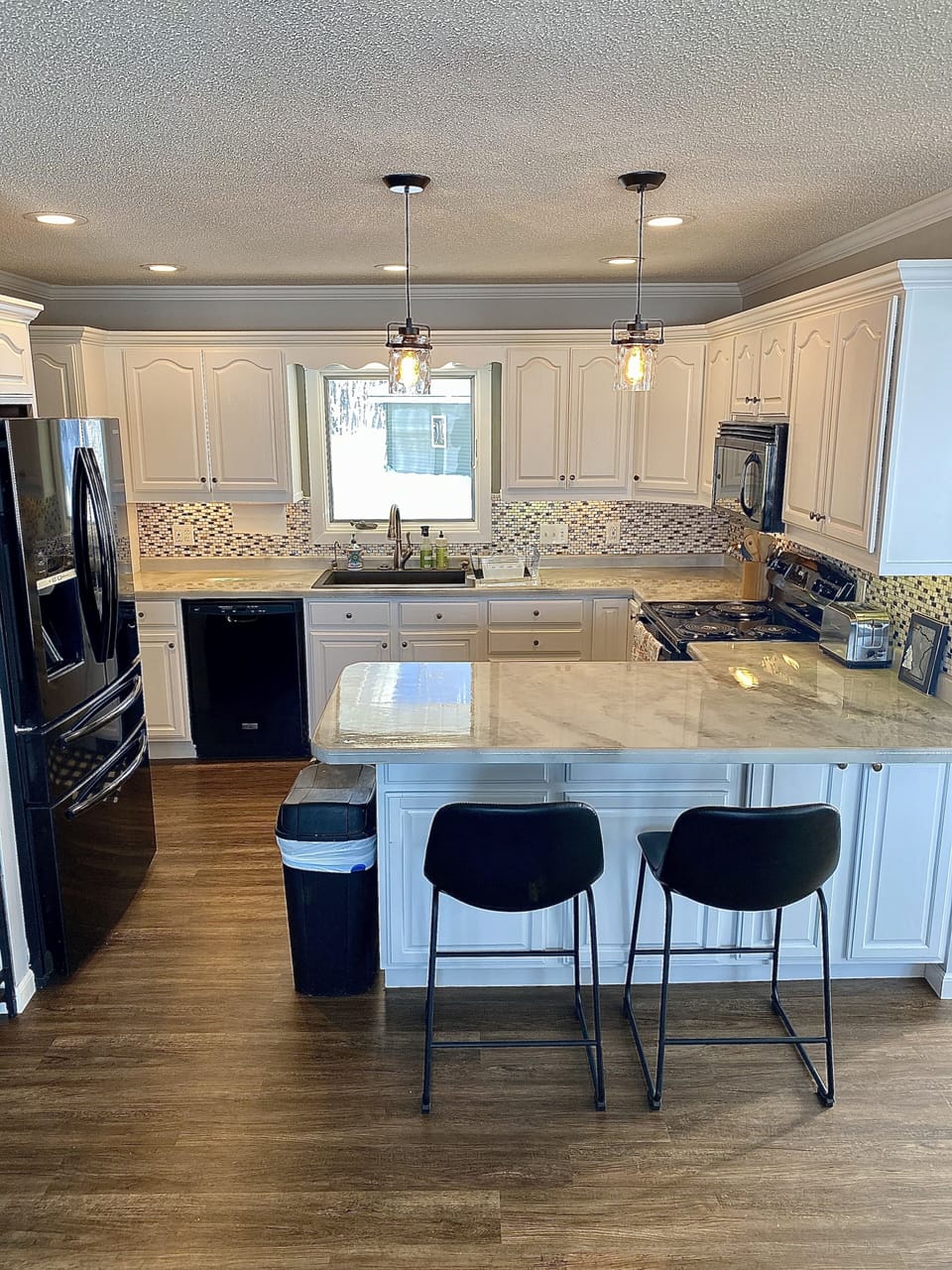 Plenty of kitchen counter space with barstools.  Dishwasher in the kitchen! 
