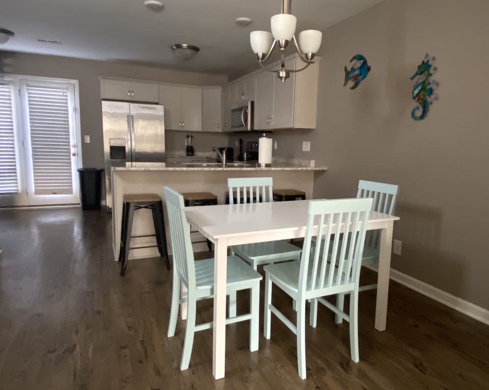 Dining room with kitchen in the background
