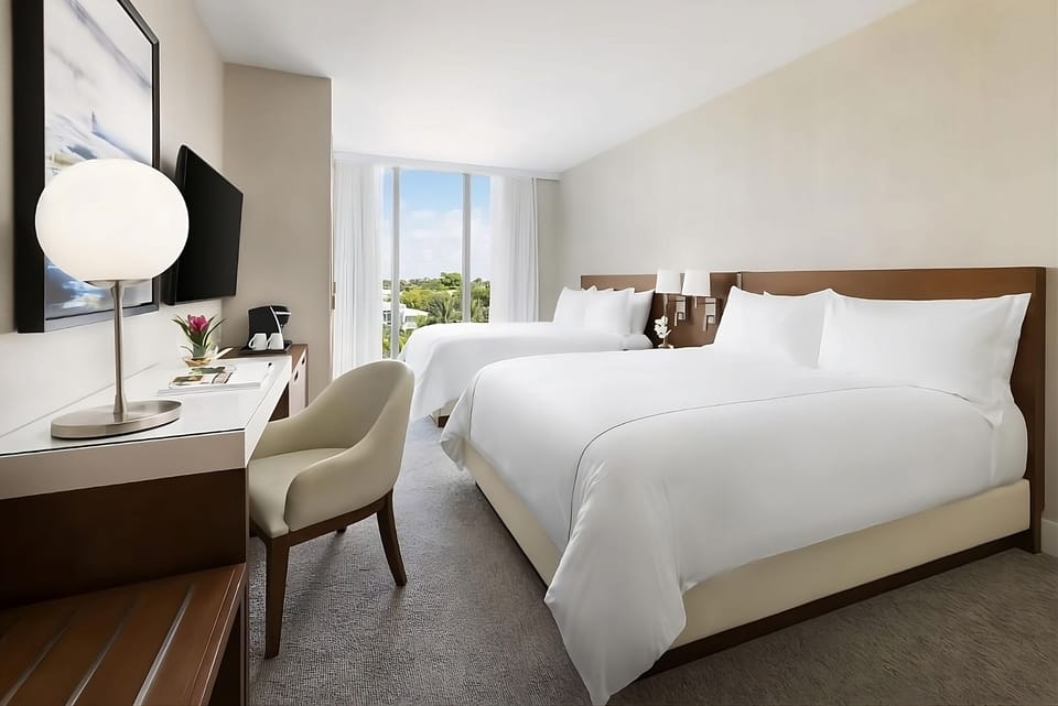 Settle into crisp linens and wake to sunny balcony views.
