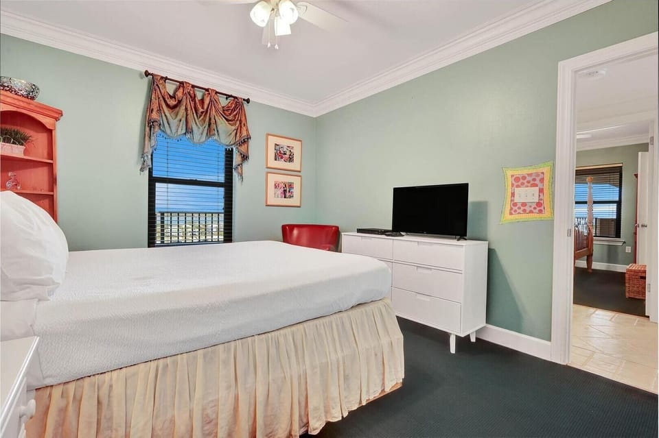 Discover serenity in this calming bedroom, equipped with a smart TV for entertainment. Its cozy and inviting ambiance, perfect for relaxation, is coupled with well-appointed modern amenities for added convenience.