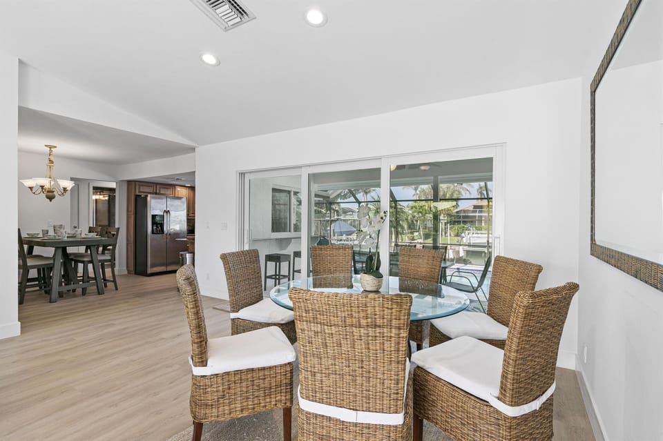 Dine Inside in an Elegant Space, Surrounded by the Tranquil Beauty of Pool and Canal Vistas.