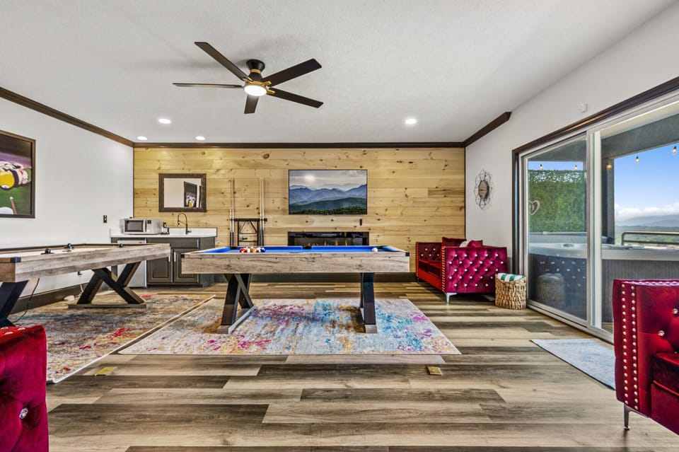 Family Room (Lower Level) : Spacious family room featuring a vibrant, welcoming design, perfect for game nights with the whole family  