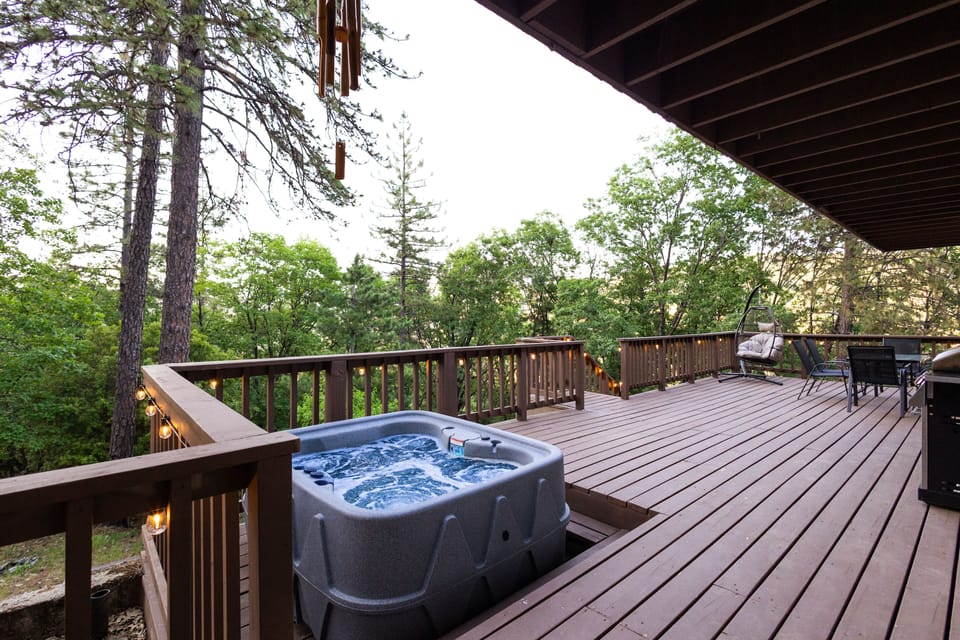 First level deck with hot tub, BBQ grill, egg chair and dining table