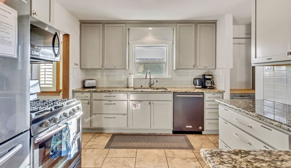 Well-stocked kitchen incl pots/pans, coffee maker, teapot, pantry items, & more.