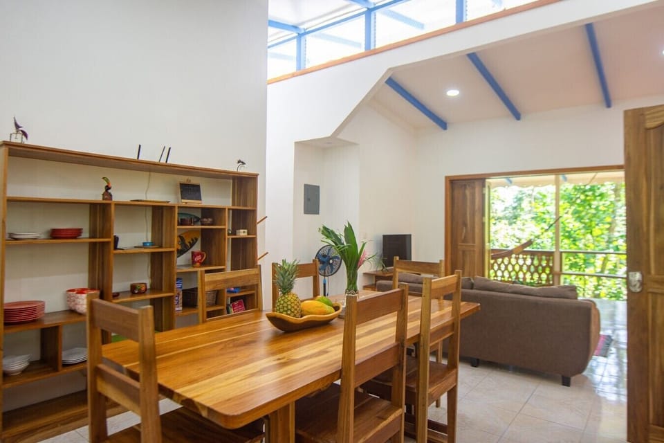 Open-concept dining area for 6 guests, seamlessly connected to the living room and jungle-view terrace, Blue Maverick in Puerto Viejo.