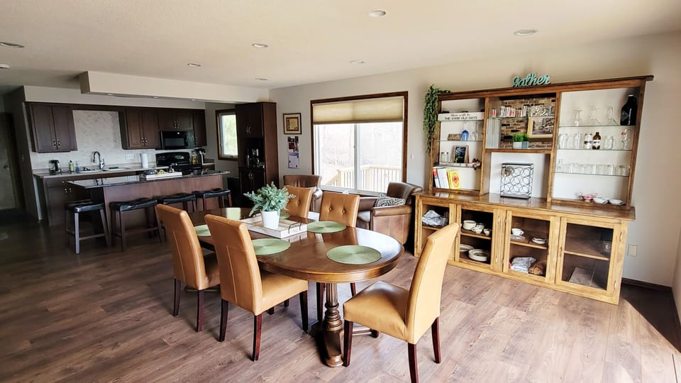 Dining area connected to the kitchen seats 8 at the table and 4 at the island.