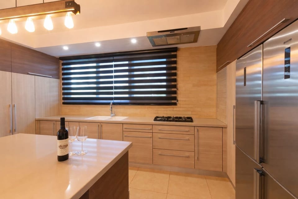 Spacious kitchen with ample counter space ideal for group meals during convenient well located stay