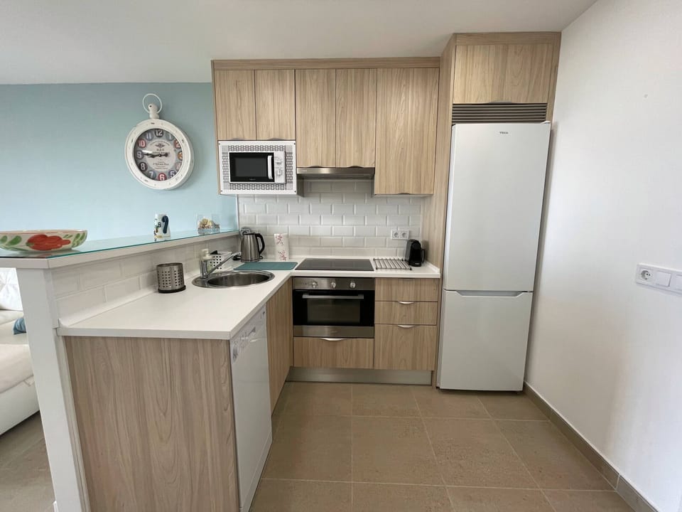 Fully equipped modern kitchen open to the living/dining room.