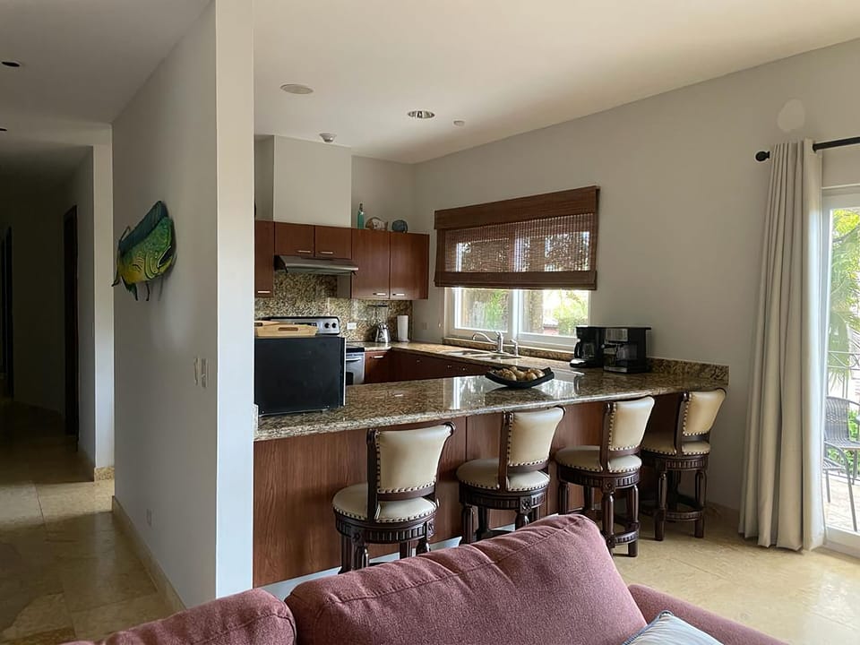 Kitchen includes 4 barstools, dishwasher, fridge, microwave and stove