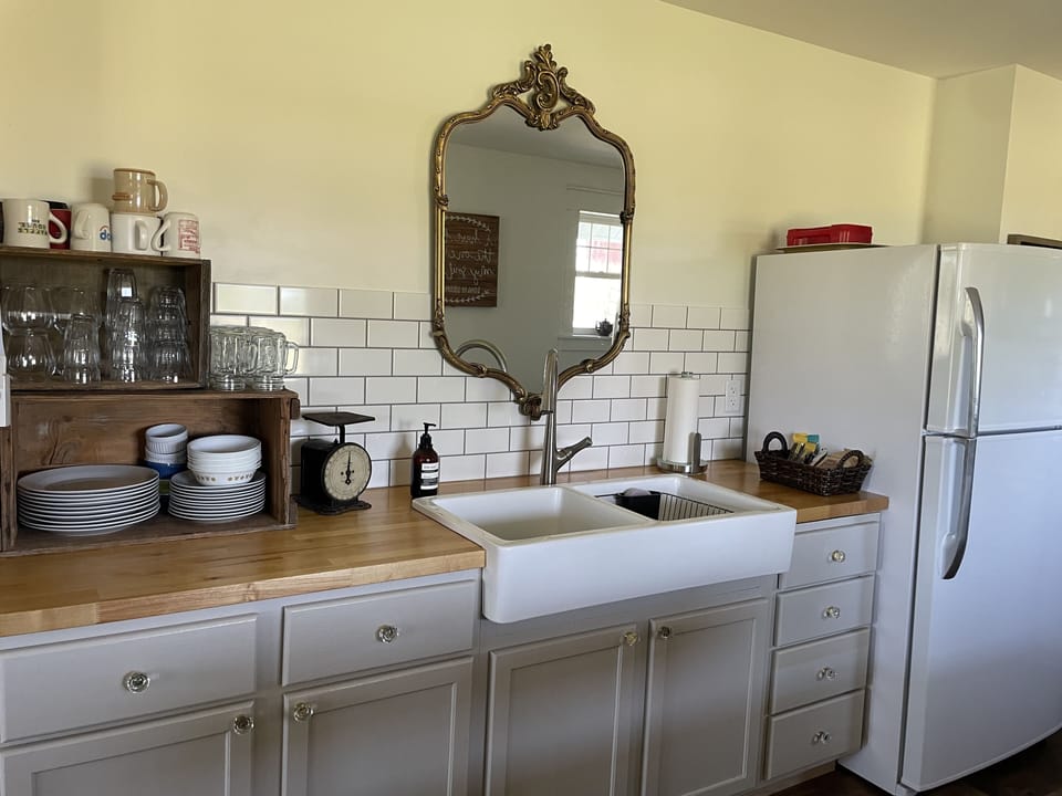 Kitchen with all the basic kitchen supplies as well as oil and spices