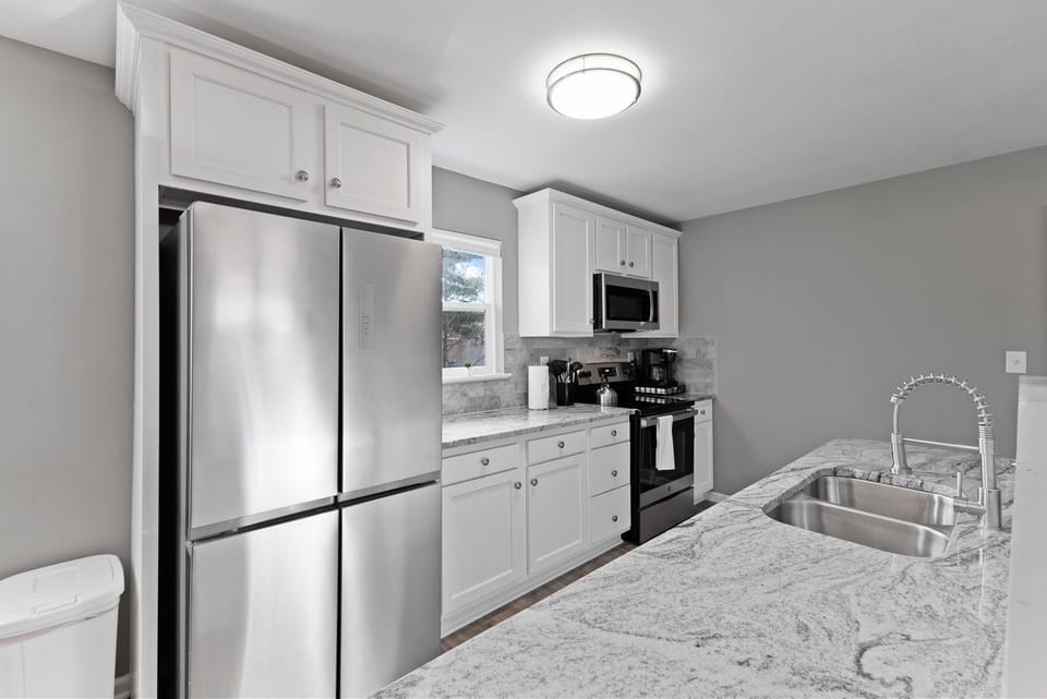 Modern kitchen appliances include an electric range