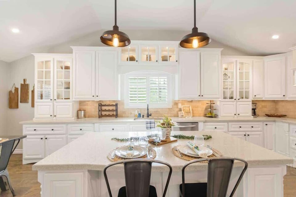 Stylish kitchen island with sleek pendant lights hanging above.