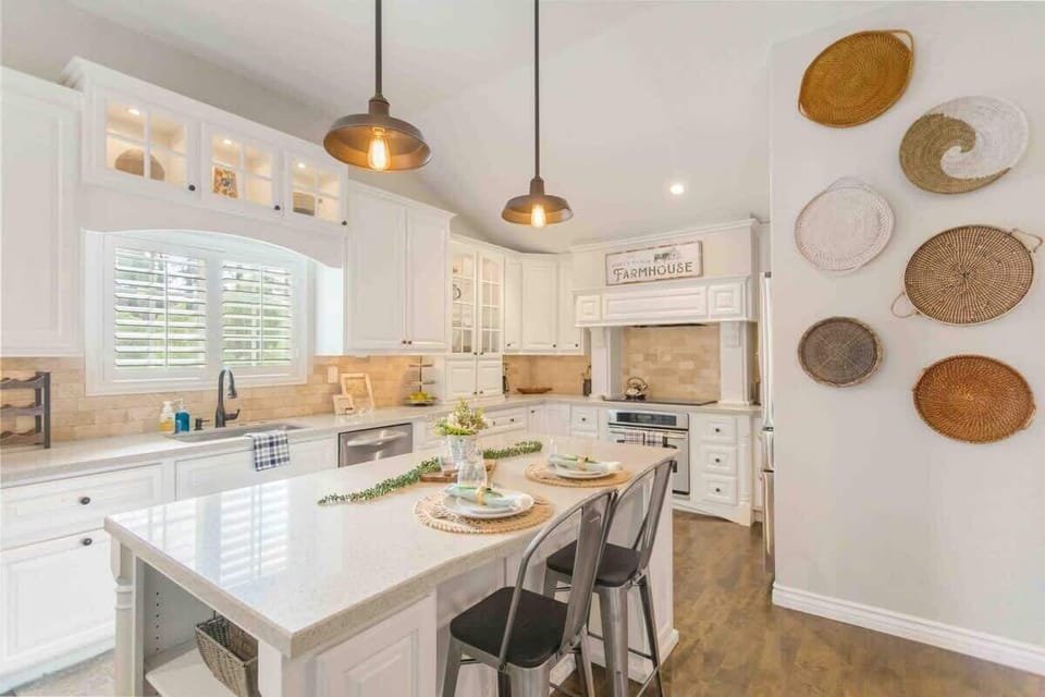Stylish kitchen with a spacious island, adorned with elegant pendant lights.