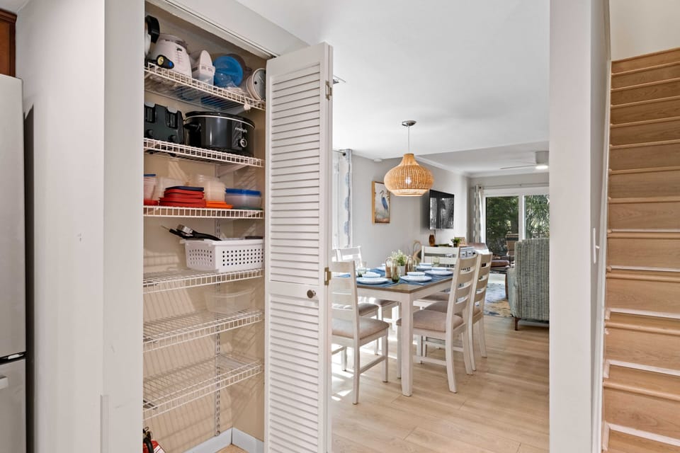 The pantry contains a waffle maker, crock pot, blender, grilling tools, & more.