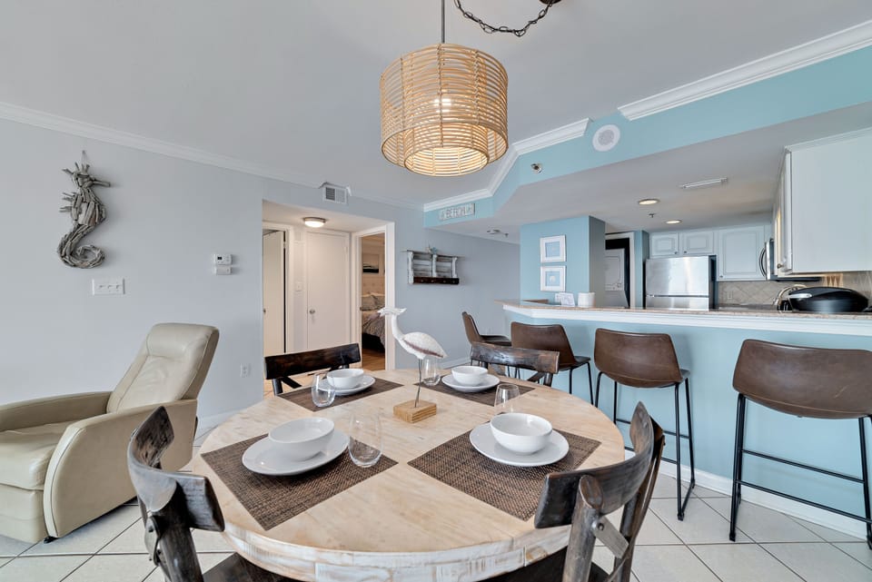 Dine in style with ample space for everyone. This inviting dining area at Summerchase features a charming table for family meals, complemented by additional seating at the convenient breakfast bar.