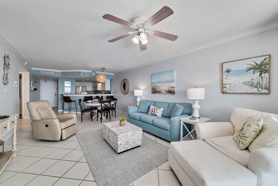 A comfortable living room with ample seating, flowing into a dining area, ideal for everyday living and gatherings.