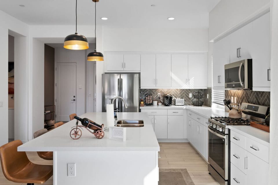 Modern kitchen w/ large island, bar seating & sleek appliances for easy meals