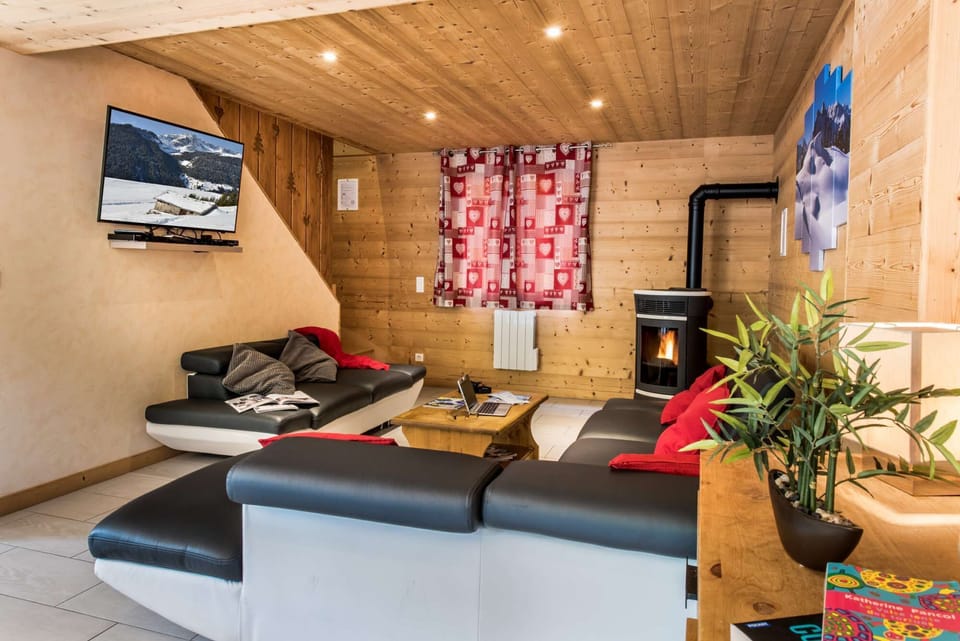 Cosy lounge with stove and sofas in Chalet Snow Angel in le Bettaix