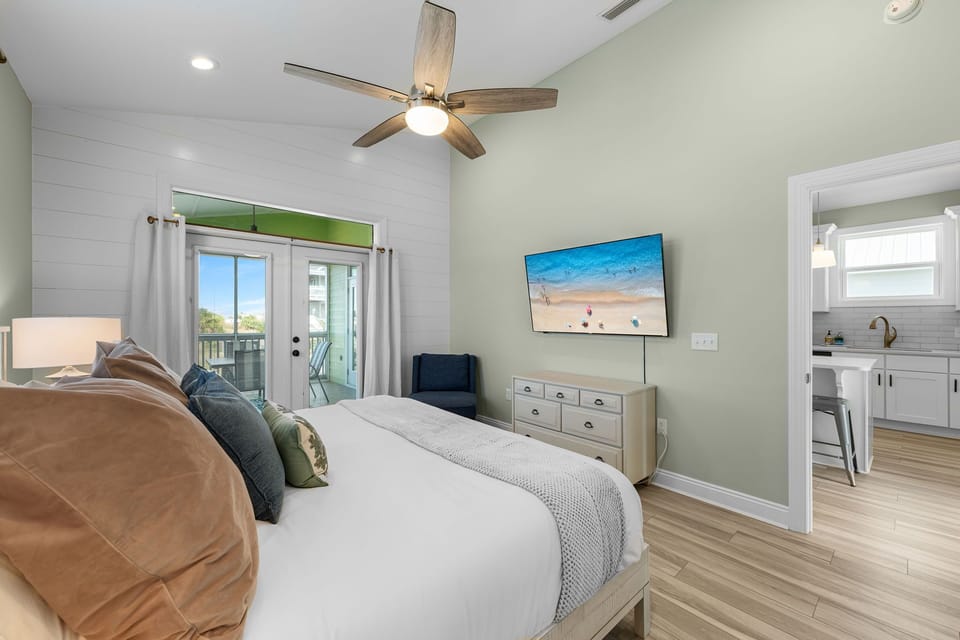 Enjoy coffee on the screened in porch located immediately off the primary suite