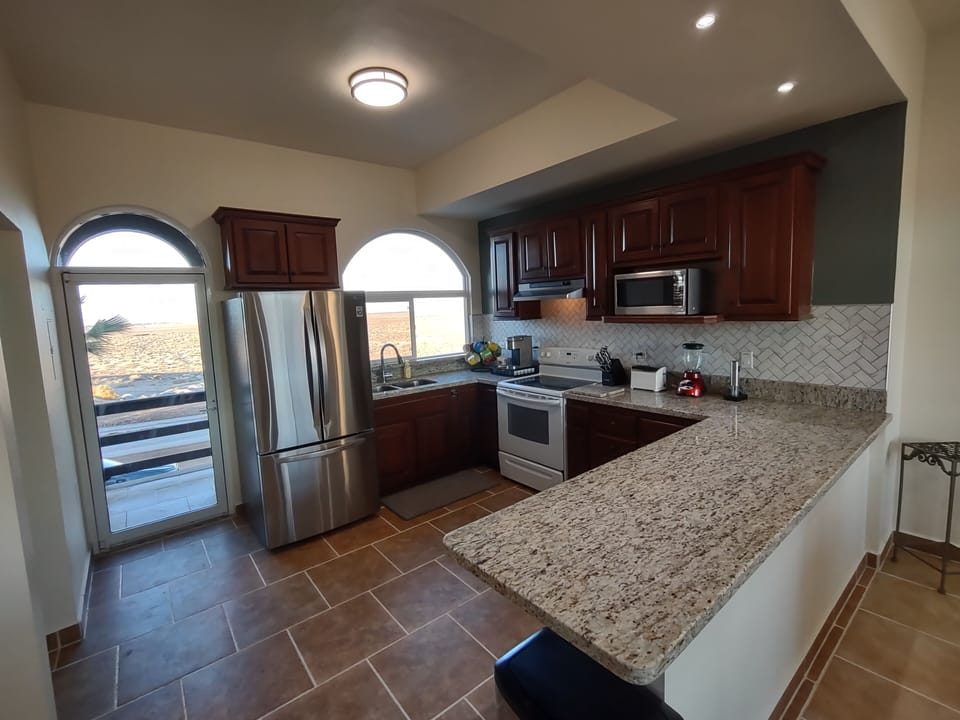 Kitchen with new granite counters, microwave, full size stove/oven, keurig.