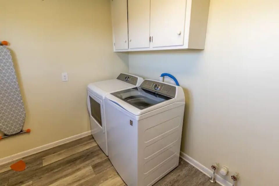 Brand new Washer and Dryer in the pantry complete with Ironing board and iron.