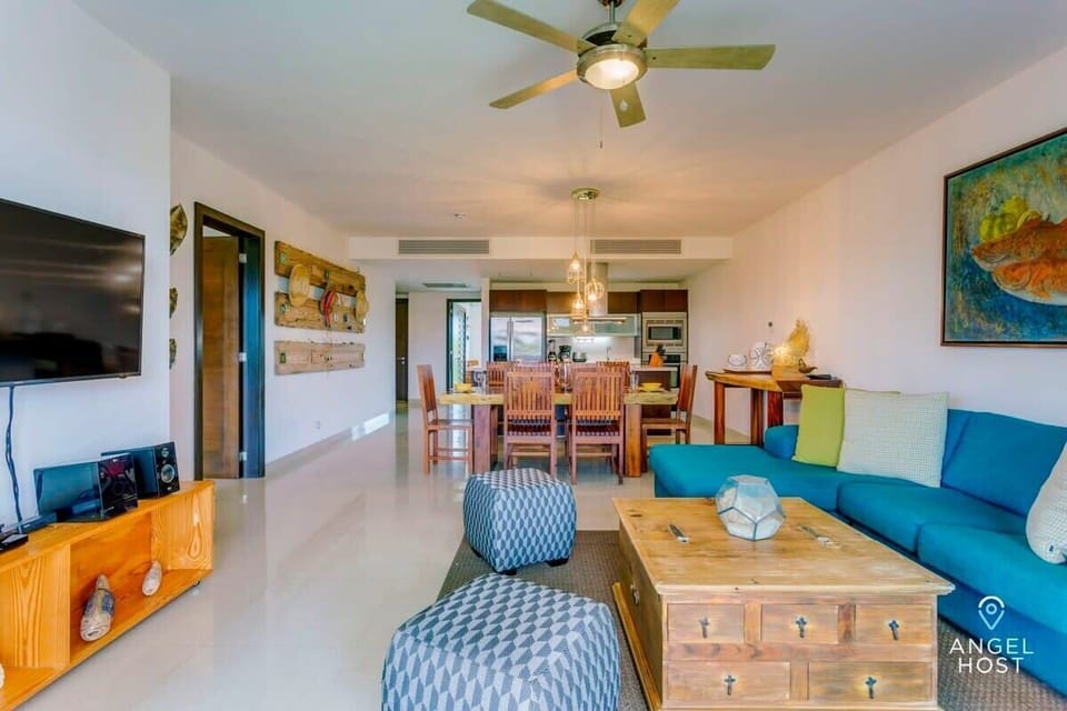 A beautifully designed open floor concept with beautiful natural wood furniture and colorful décor