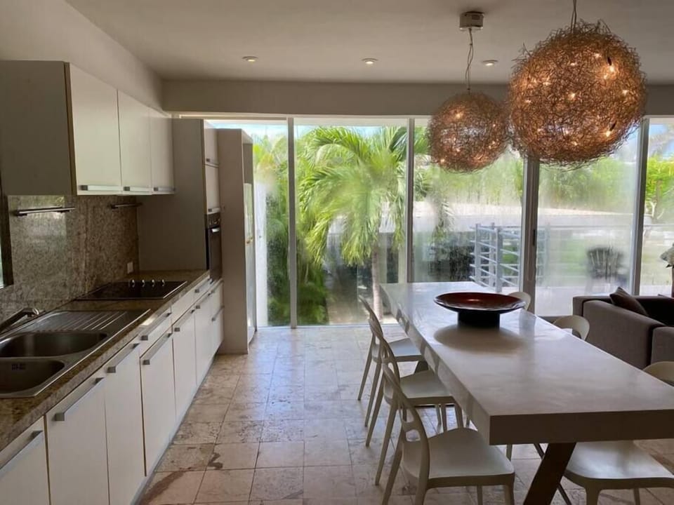 Fully equipped kitchen with garden views, ideal for cooking meals at home.