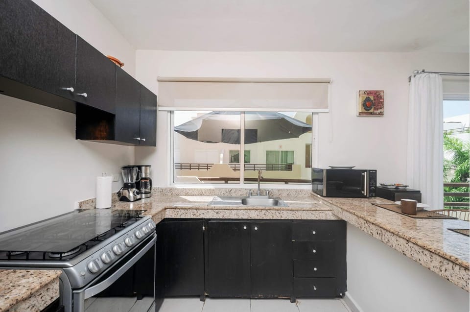 A fully-equipped kitchen with all the appliances & utensils to prepare meals at home