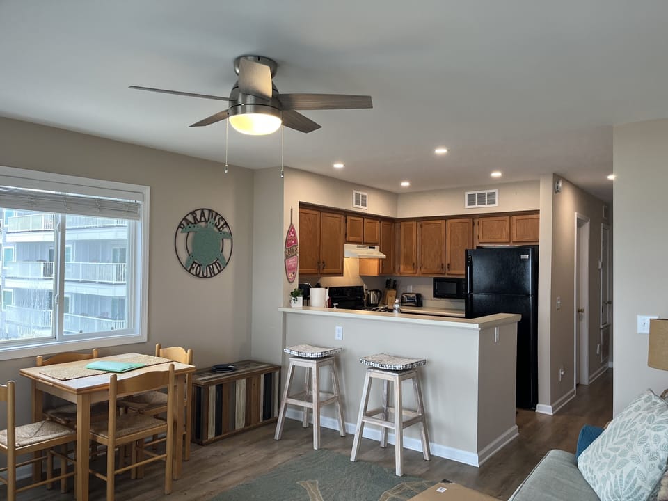Kitchen with bar area and eating table that pulls out for 4