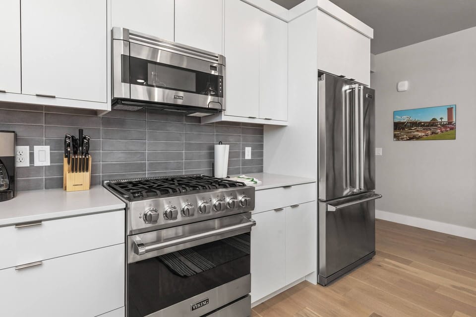 Mayflower Lakeside 104: Modern appliances and ample storage in sleek kitchen design.